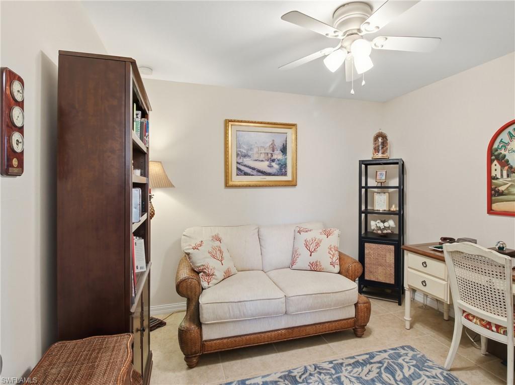 20161 Bravada Street, Unit 2 Estero, FL 33928 - Photo 14 of 33 a spacious bedroom with a bed and a chandelier