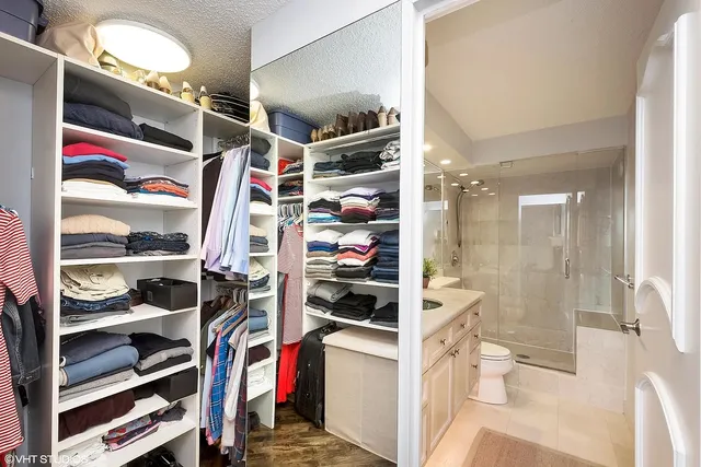 a view of walk in closet and window