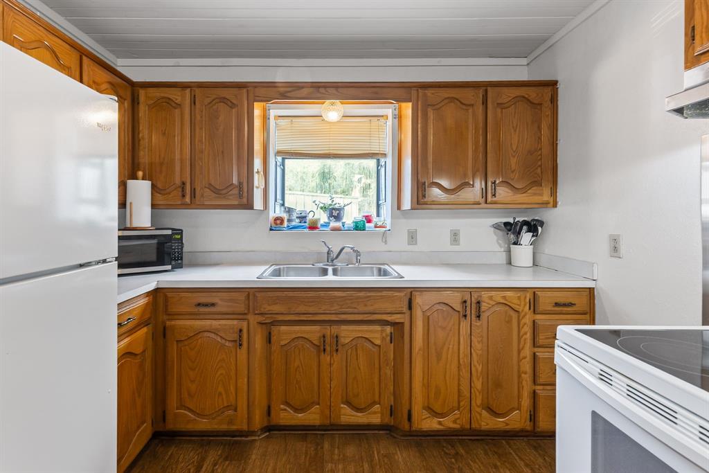 206 North Main Street Bailey, TX 75452 - Photo 11 of 30 a kitchen with a sink cabinets and window