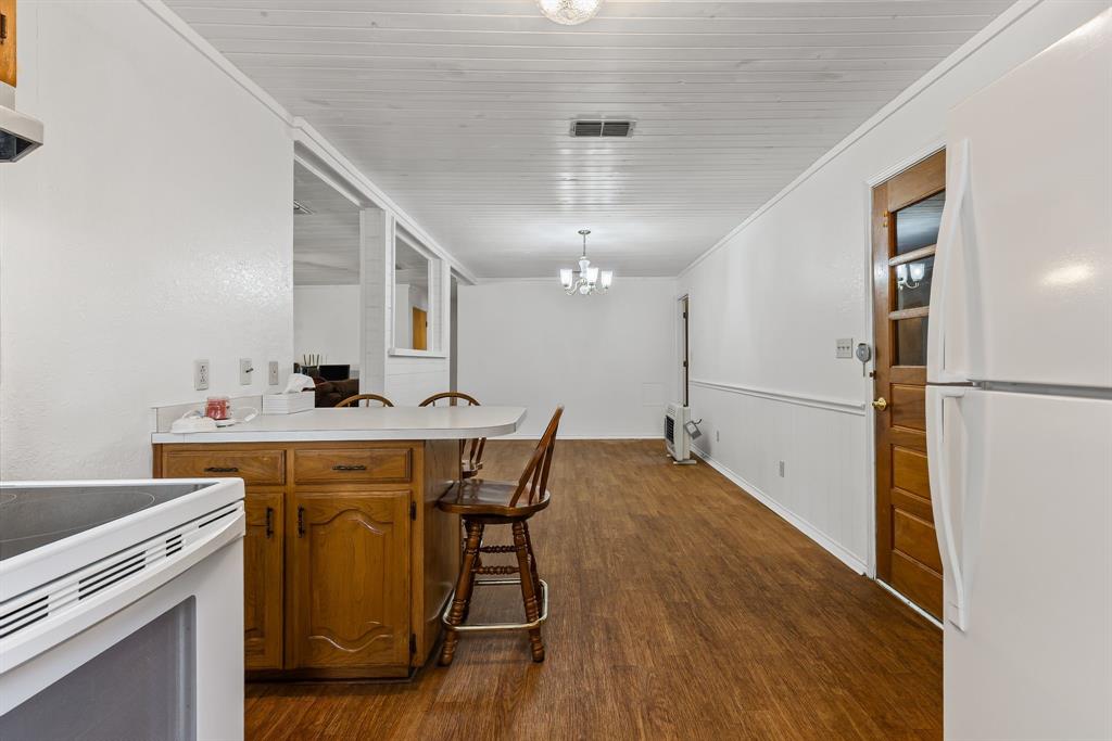 206 North Main Street Bailey, TX 75452 - Photo 12 of 30 a view of a dining room with furniture and wooden floor