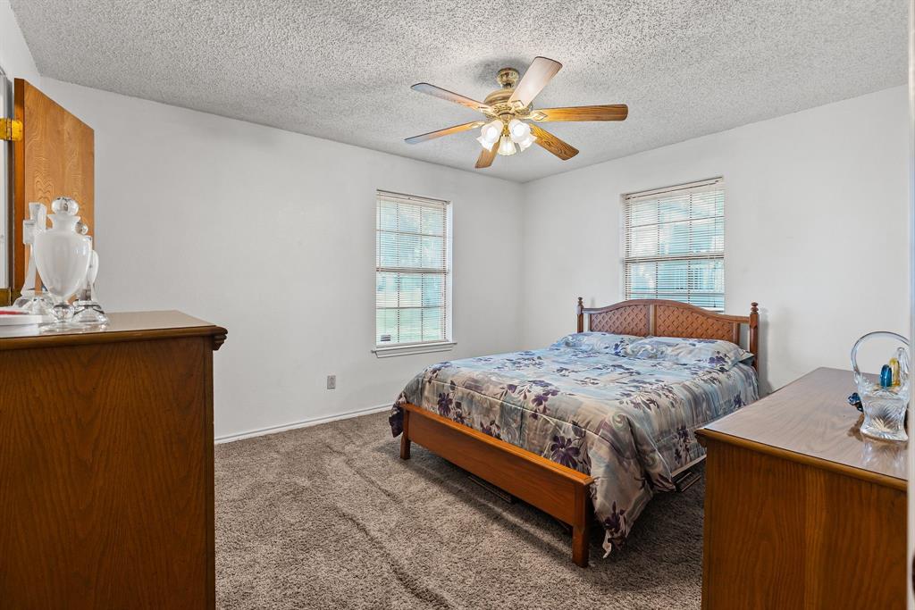 206 North Main Street Bailey, TX 75452 - Photo 13 of 30 a bedroom with a bed and a flat screen tv