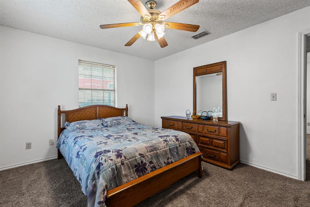 206 North Main Street Bailey, TX 75452 - Photo 14 of 30 a bedroom with a bed and a chandelier