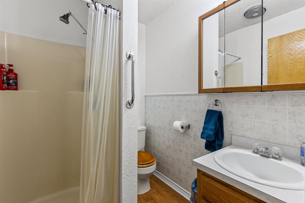 206 North Main Street Bailey, TX 75452 - Photo 15 of 30 a bathroom with a sink a toilet and shower