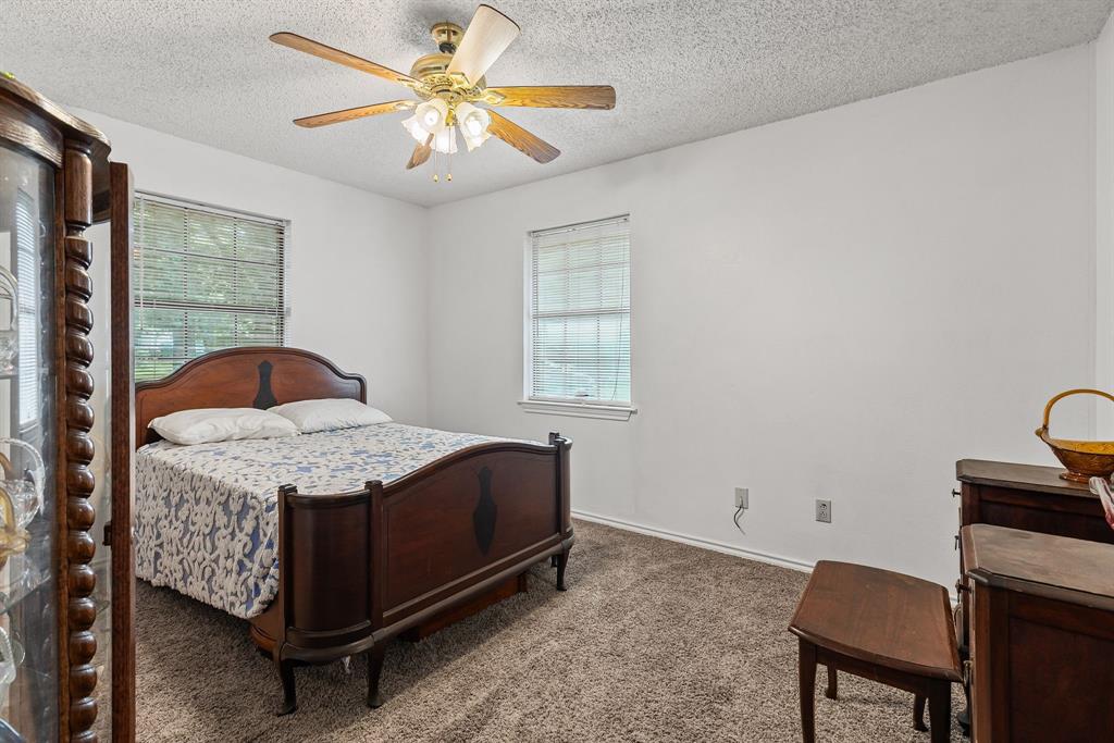 206 North Main Street Bailey, TX 75452 - Photo 18 of 30 a bedroom with a bed and a chandelier