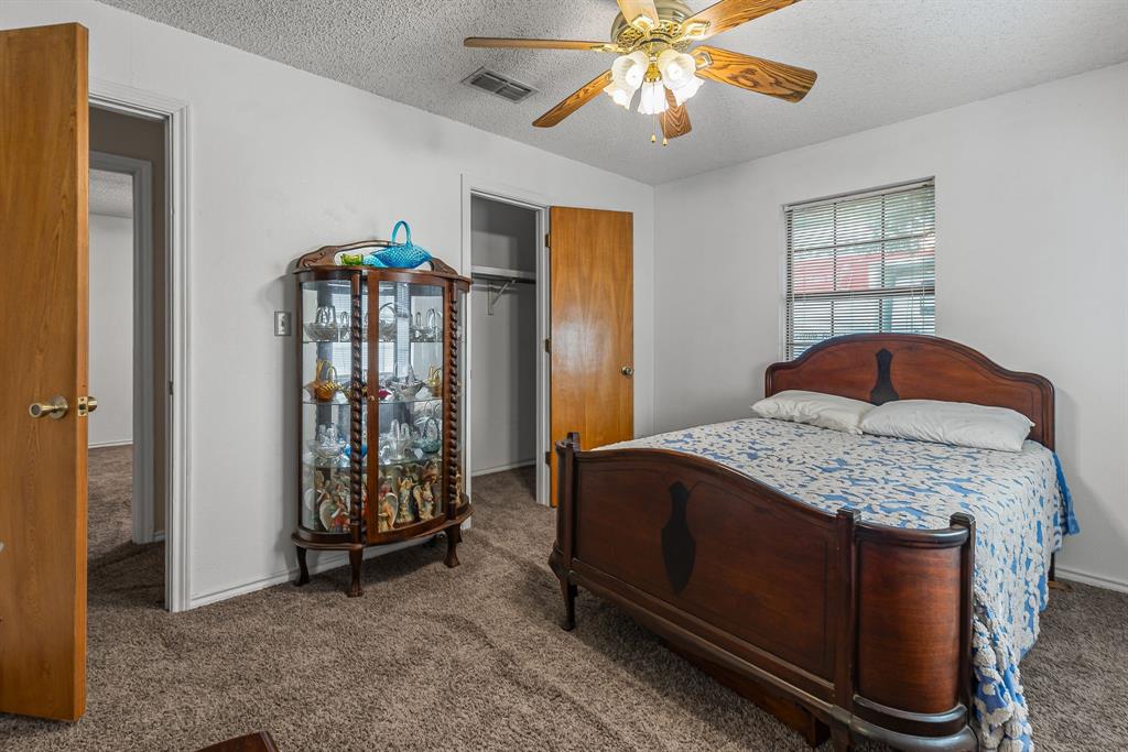 206 North Main Street Bailey, TX 75452 - Photo 19 of 30 a bedroom with a bed and a chandelier