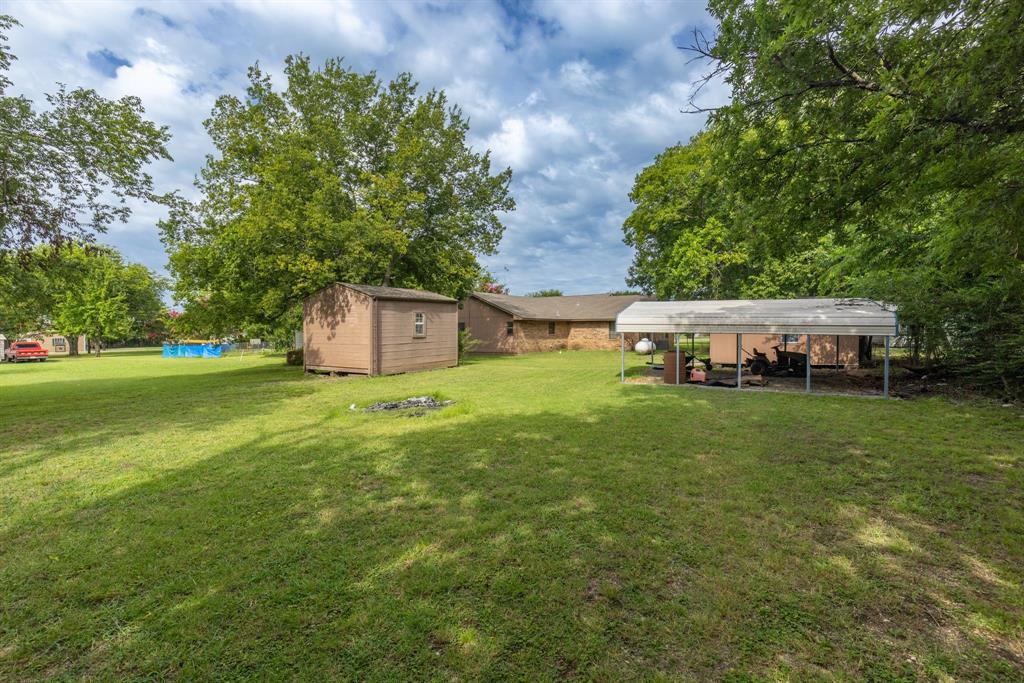 206 North Main Street Bailey, TX 75452 - Photo 23 of 30 a view of a house with a yard and sitting area