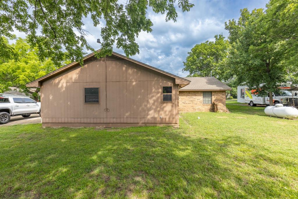 206 North Main Street Bailey, TX 75452 - Photo 25 of 30 a backyard of a house with table and chairs