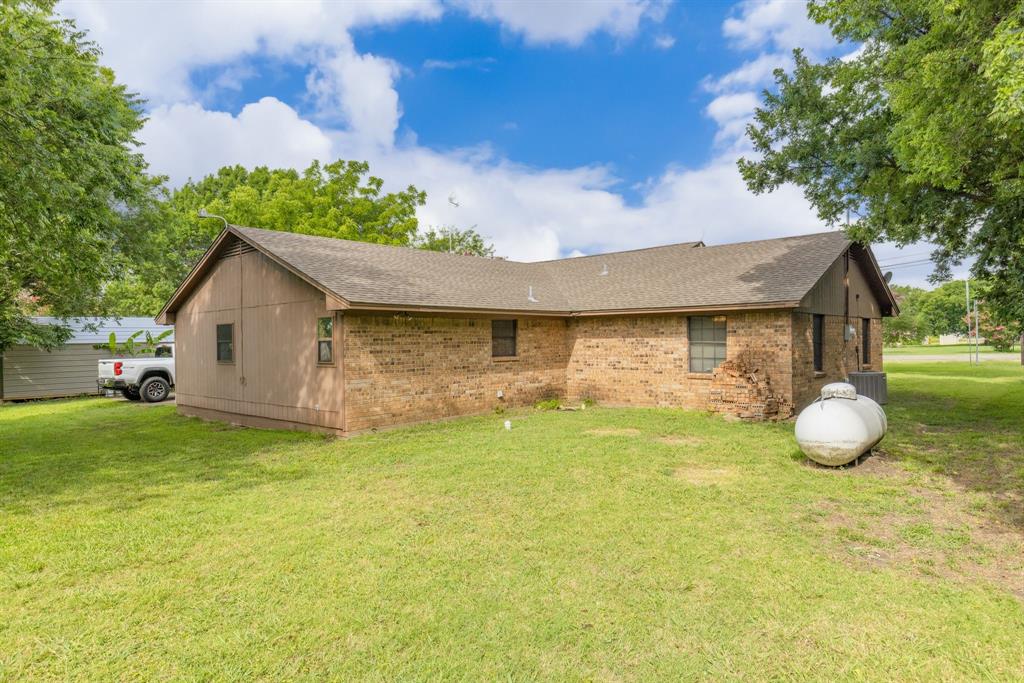 206 North Main Street Bailey, TX 75452 - Photo 26 of 30 a front view of a house with a garden
