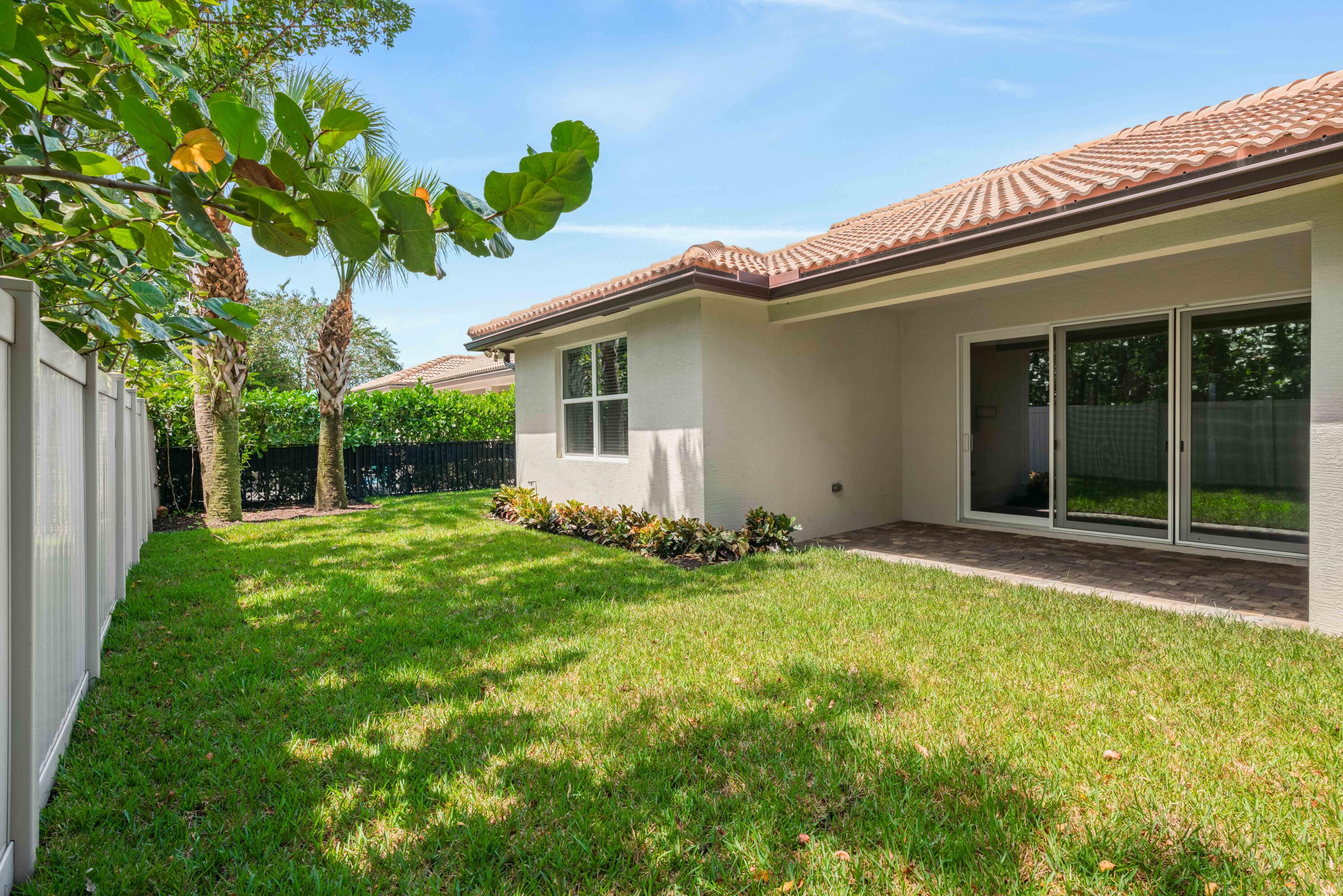 7018 Limestone Cay Road Jupiter, FL 33458 - Photo 13 of 23 front view of a house with a yard