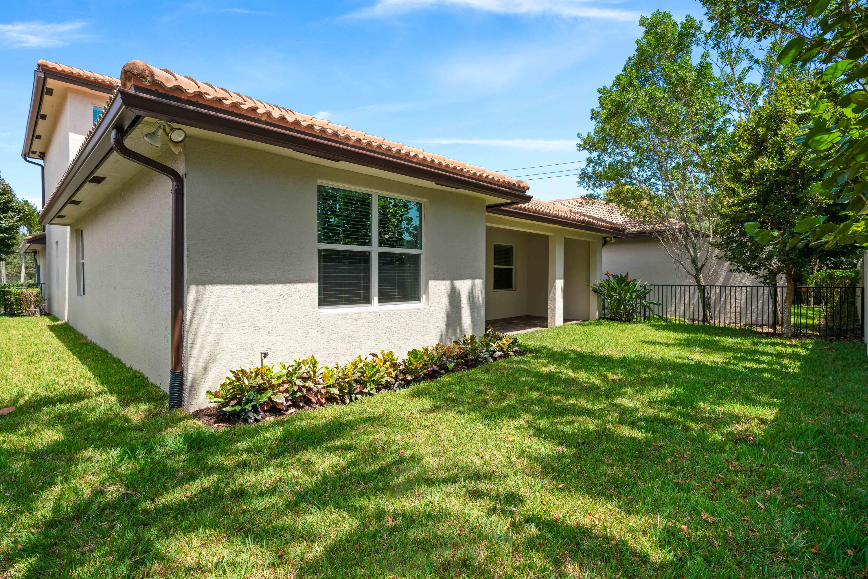 7018 Limestone Cay Road Jupiter, FL 33458 - Photo 14 of 23 a house with green field in front of it