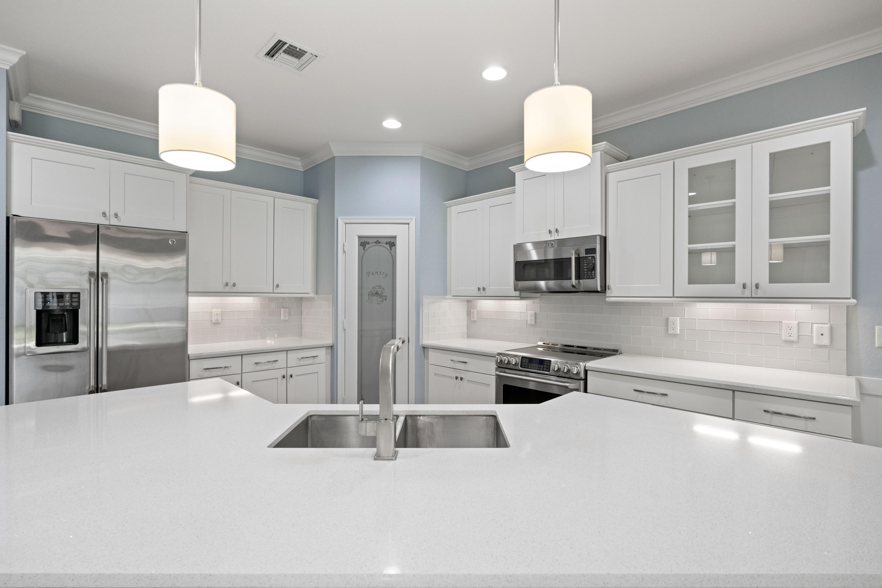 7018 Limestone Cay Road Jupiter, FL 33458 - Photo 16 of 23 a kitchen with stainless steel appliances a refrigerator and a sink