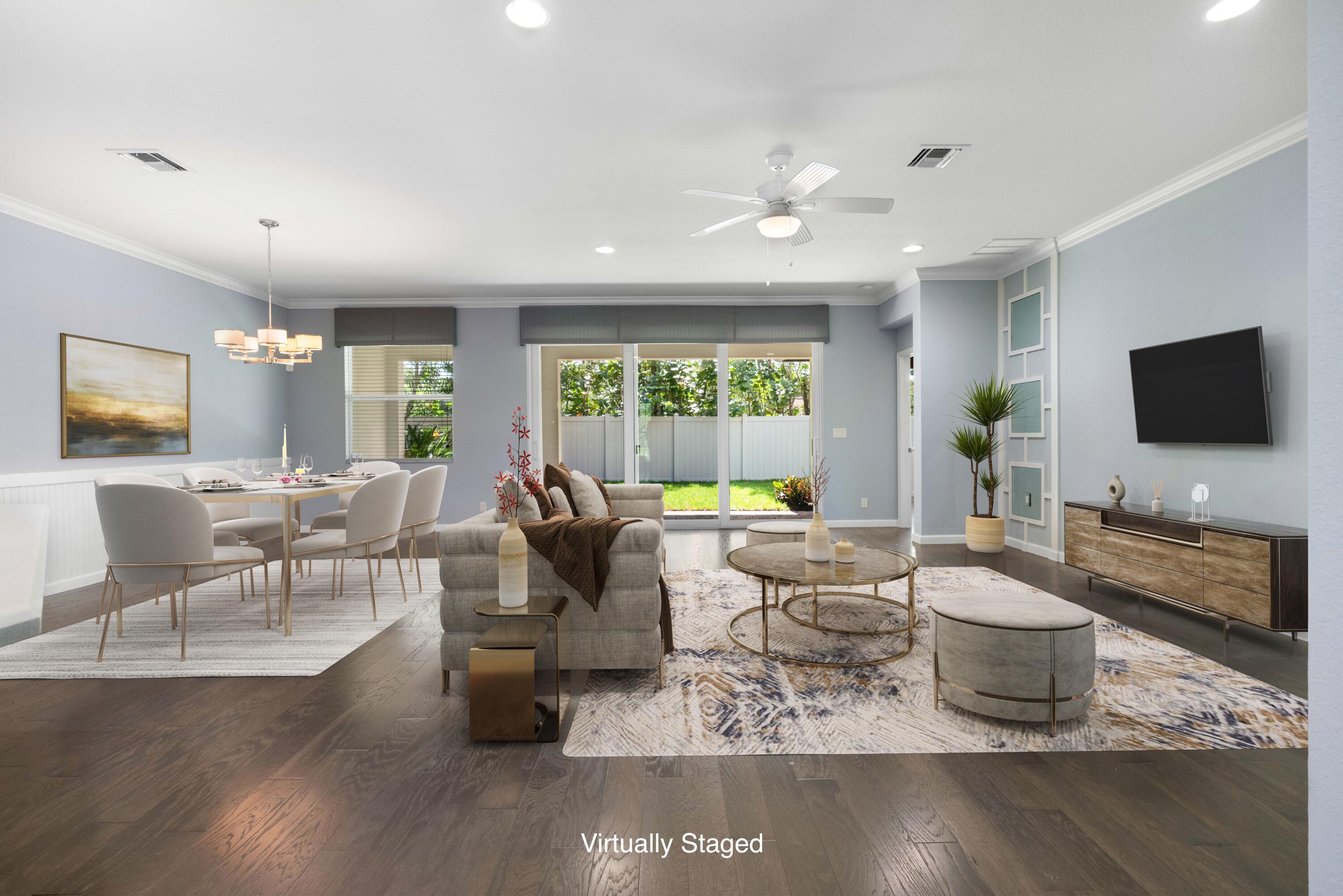 7018 Limestone Cay Road Jupiter, FL 33458 - Photo 2 of 23 a living room with furniture and a flat screen tv