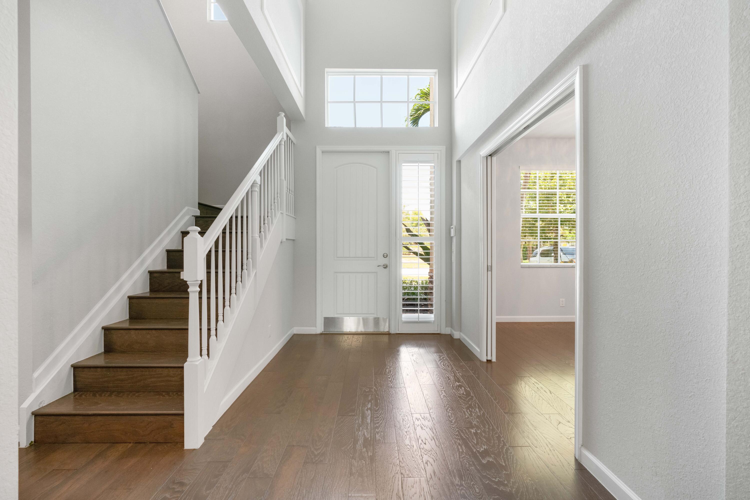 7018 Limestone Cay Road Jupiter, FL 33458 - Photo 10 of 23 a view of an entryway with wooden floor and windows