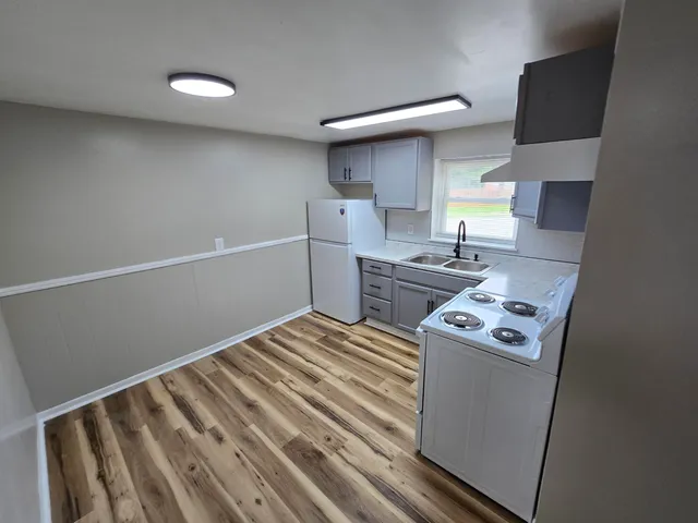 a kitchen with a stove and a refrigerator