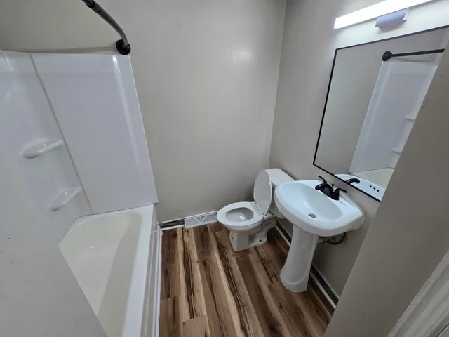 a bathroom with a sink toilet and shower