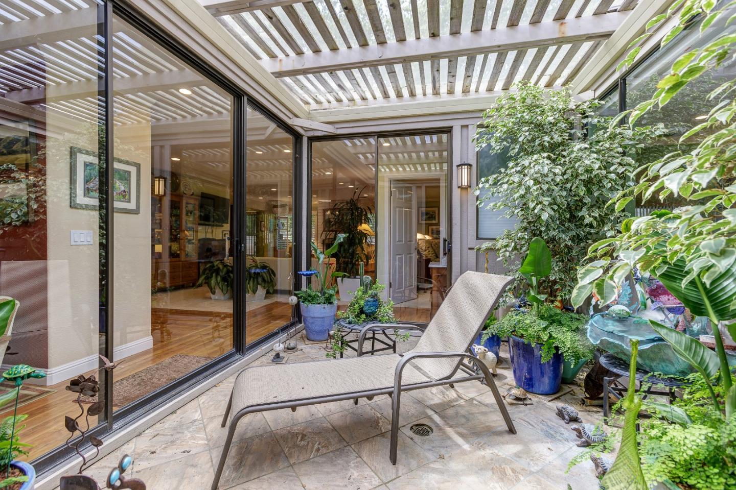 26 Deep Well Lane Los Altos, CA 94022 - Photo 28 of 39 a view of a patio with a table and chairs and potted plants