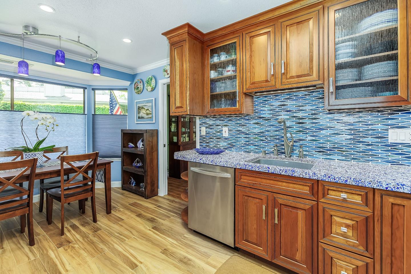 26 Deep Well Lane Los Altos, CA 94022 - Photo 7 of 39 a kitchen with stainless steel appliances granite countertop wooden cabinets a dining table and chairs