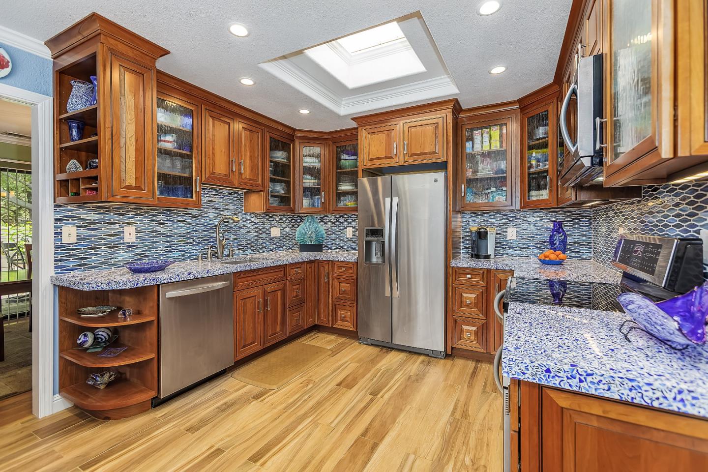26 Deep Well Lane Los Altos, CA 94022 - Photo 8 of 39 a kitchen with stainless steel appliances granite countertop a refrigerator and wooden cabinets