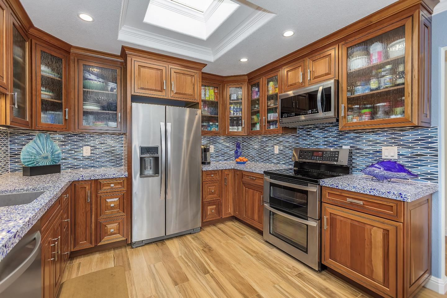 26 Deep Well Lane Los Altos, CA 94022 - Photo 9 of 39 a kitchen with stainless steel appliances granite countertop a refrigerator stove and sink