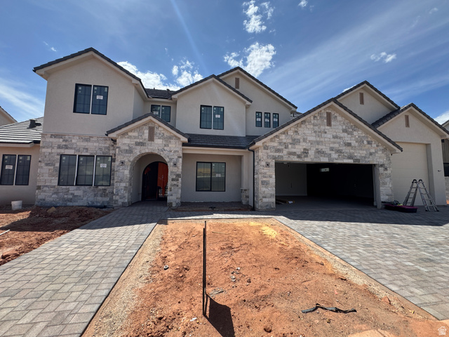 330 Homeside Road Washington, UT 84780 - Photo 1 of 1 French country style house with stucco siding, decorative driveway, an attached garage, and stone siding