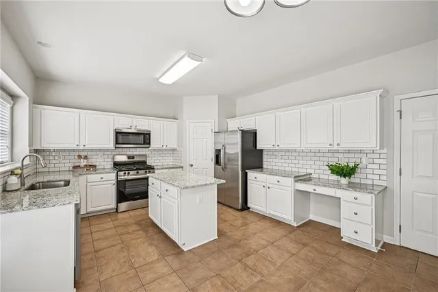 a living room with furniture fireplace and a large window