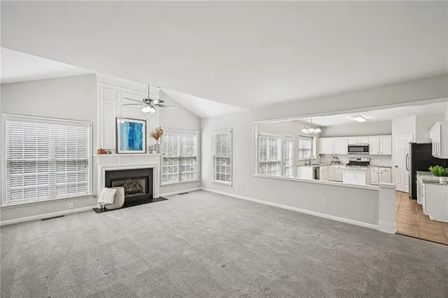 a bathroom with a granite countertop sink toilet and a mirror