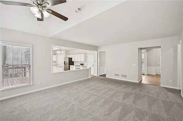 a spacious bedroom with a bed and window