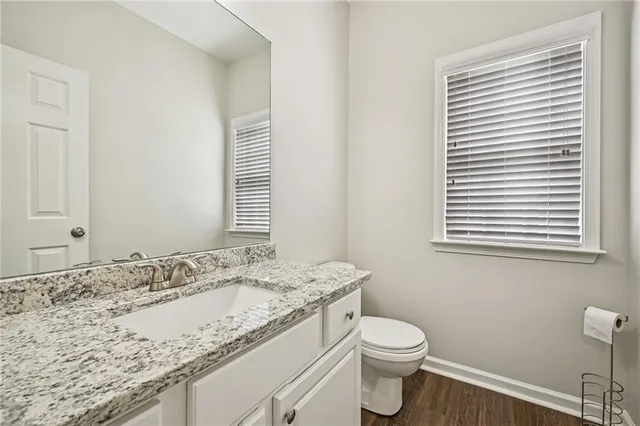 a spacious bathroom with a granite countertop sink mirror and bathtub