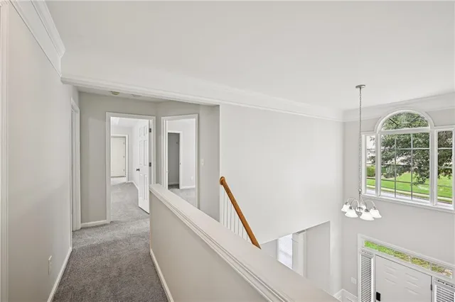 a large bathroom with a granite countertop double vanity sink a mirror and a bathtub