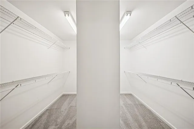 a bedroom with a bed and dresser with mirror