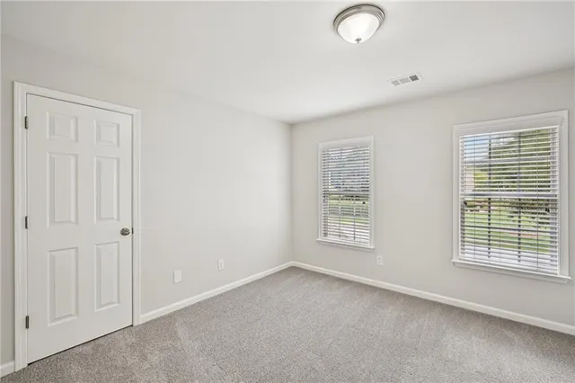 a room with pool table and windows