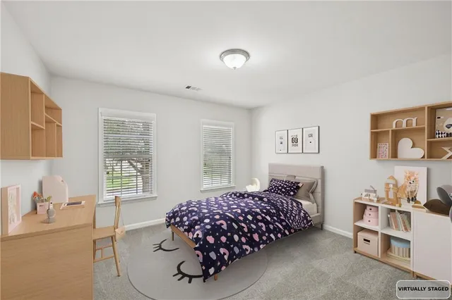 a bedroom with a bed and a potted plant