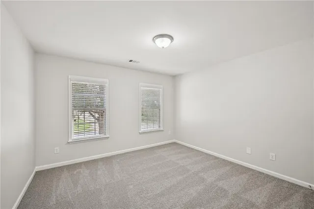 an empty room with a empty space and windows