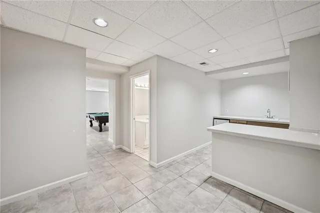 a view of a pathway of a house with backyard and wooden fence