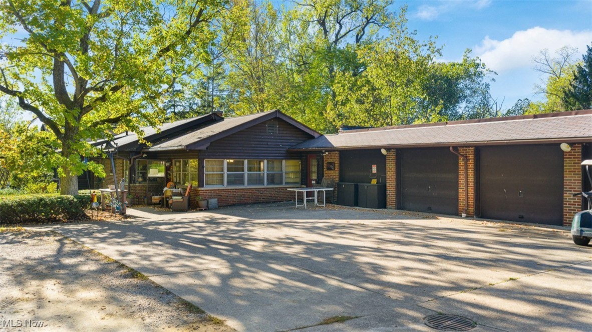 19345 Ridge Road North Royalton, OH 44133 - Photo 1 of 47 View of front facade featuring concrete driveway, brick siding, and a garage