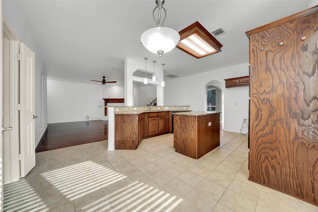 3305 Silver Springs Way Rowlett, TX 75089 - Photo 18 of 40 a kitchen with a cabinets and chandelier