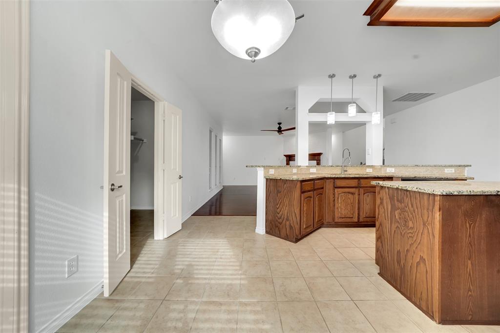 3305 Silver Springs Way Rowlett, TX 75089 - Photo 19 of 40 a large kitchen with stainless steel appliances a sink and cabinets