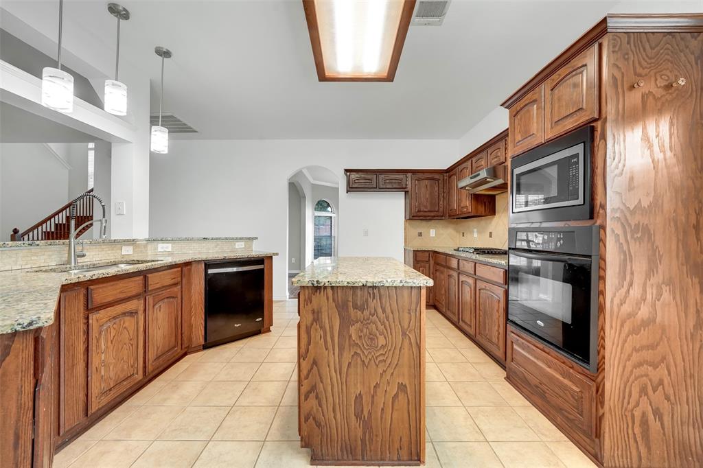 3305 Silver Springs Way Rowlett, TX 75089 - Photo 20 of 40 a kitchen with stainless steel appliances granite countertop a stove and a sink