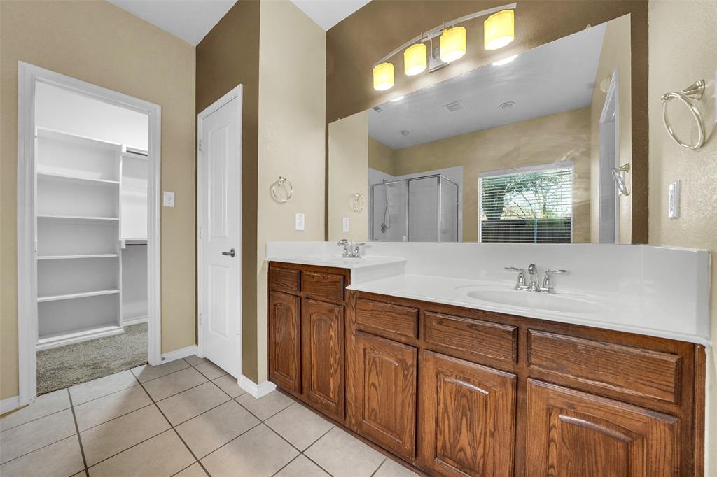 3305 Silver Springs Way Rowlett, TX 75089 - Photo 29 of 40 a bathroom with a granite countertop sink and a mirror