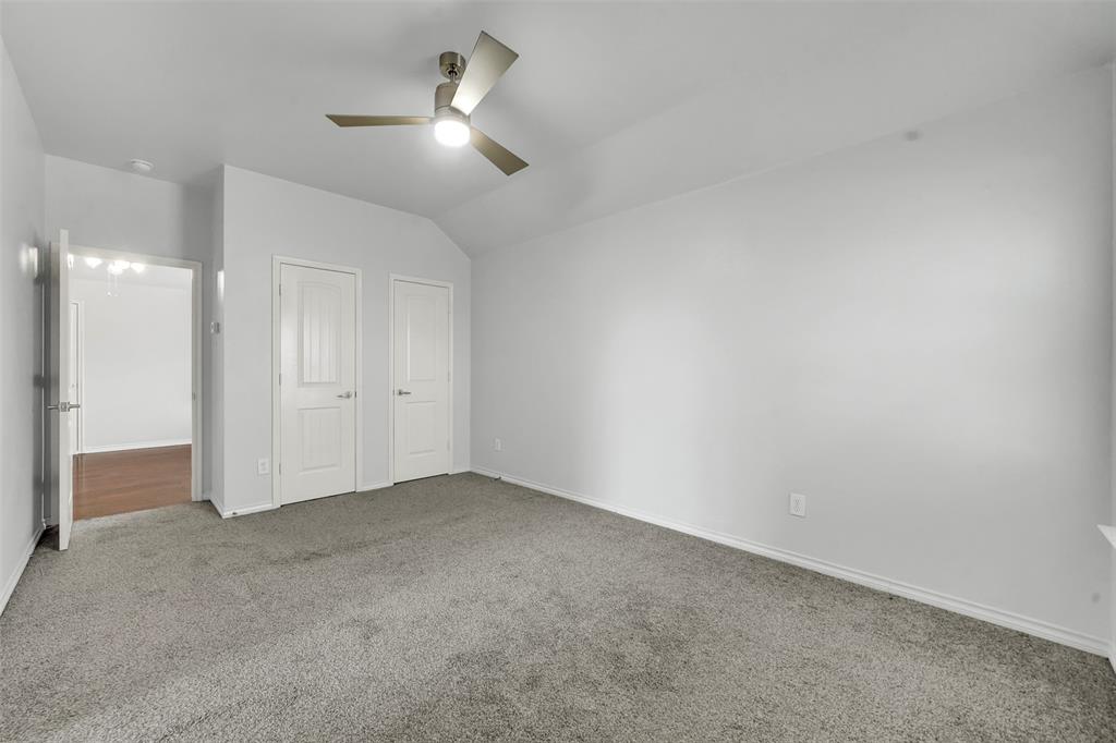 3305 Silver Springs Way Rowlett, TX 75089 - Photo 33 of 40 an empty room with a ceiling fan and a bathroom
