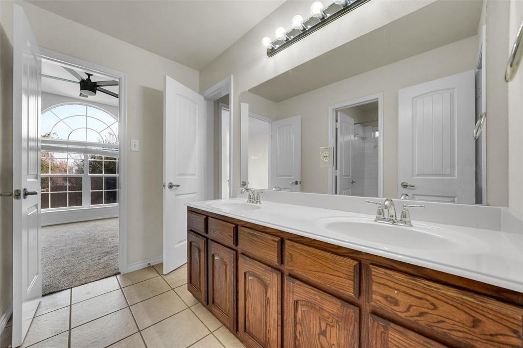 3305 Silver Springs Way Rowlett, TX 75089 - Photo 35 of 40 a bathroom with a sink and a mirror