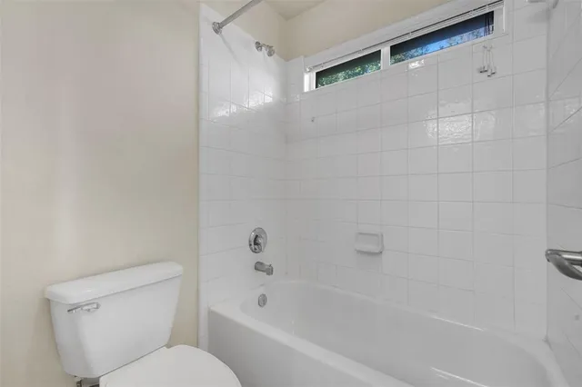 a bathroom with a toilet and bathtub