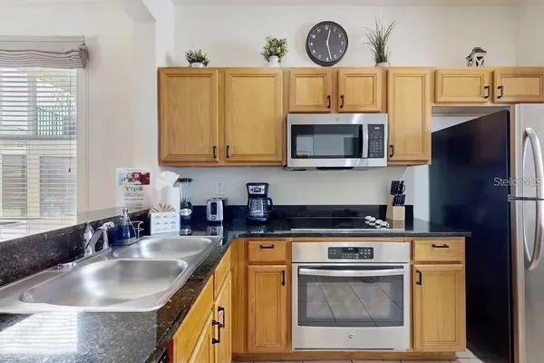 a kitchen with a stove a sink and a microwave