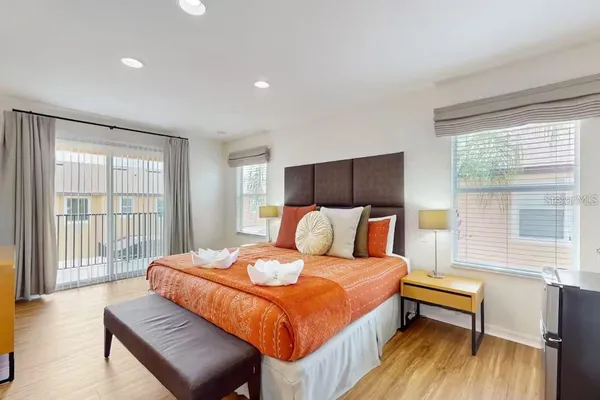 a bedroom with a bed and a large window