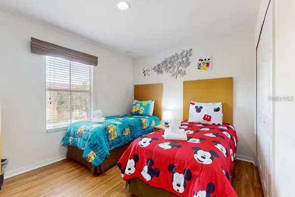 a bedroom with two beds and a window