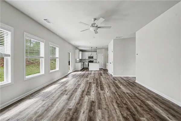 a view of a livingroom with furniture window and wooden floor