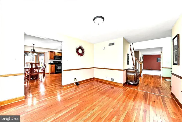 a view of a dining room with furniture wooden floor and chandelier