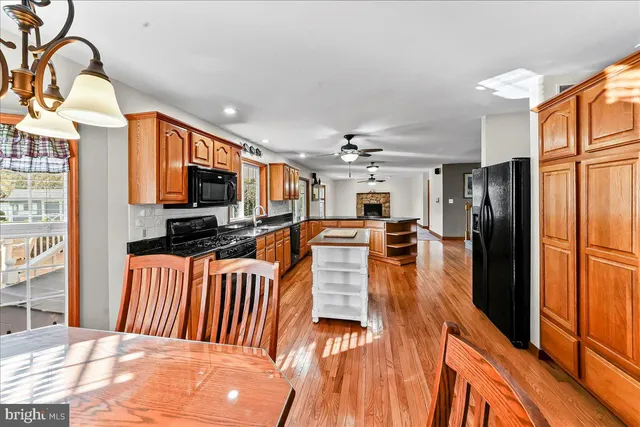 a kitchen with stainless steel appliances a stove top oven a sink and a refrigerator
