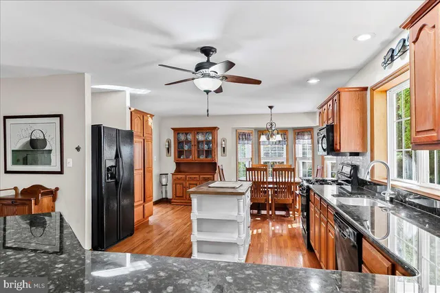 a view of a living room kitchen with furniture and wooden floor