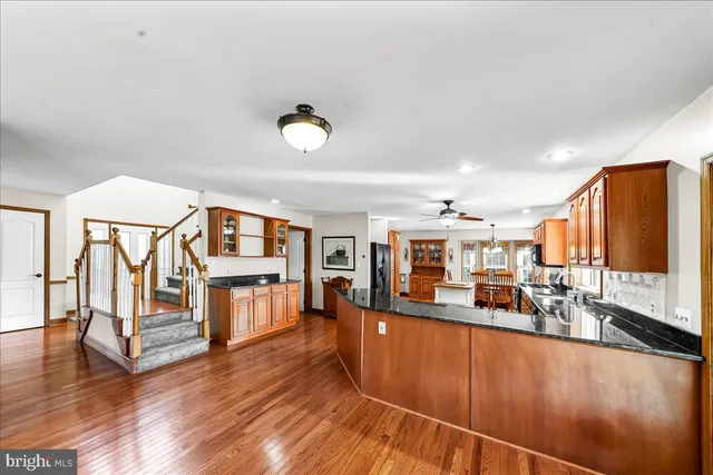 an empty room with windows and fireplace